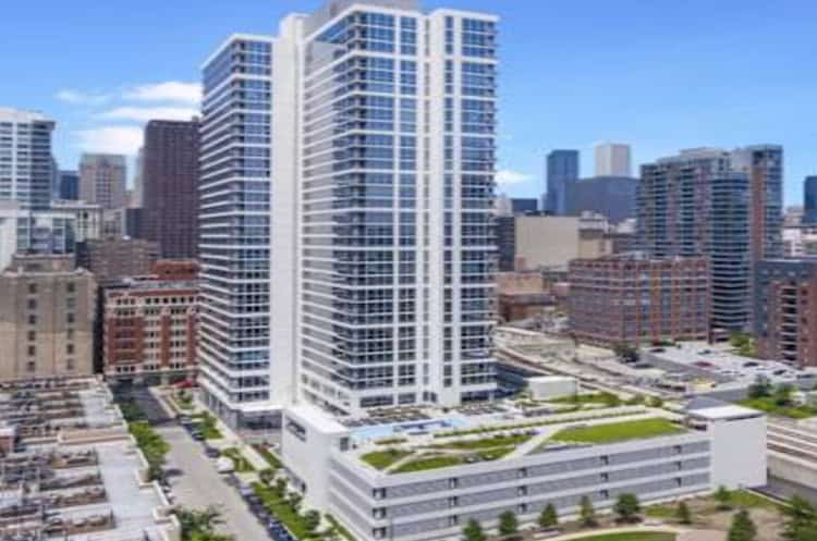 Modern high-rise residential building in downtown urban setting.